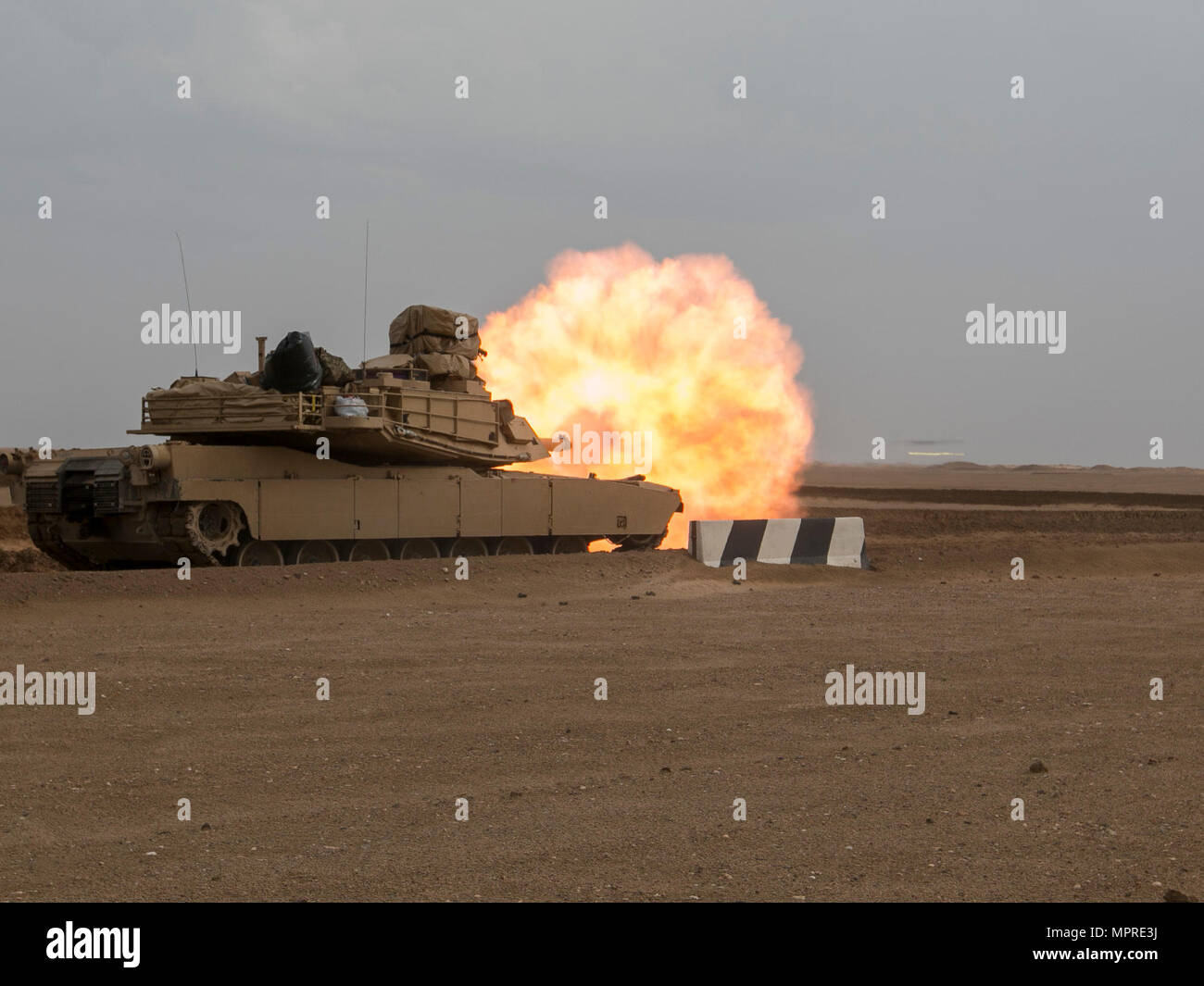 A 3rd Armored Brigade Combat Team, 1st Cavalry Division M1A2 Abrams Main Battle Tank engages targets during the brigade's Table VI qualifications at the Udairi Range Complex March 28. The brigade tank and Bradley crews spent about two weeks in the field conducting sustainment gunnery to ensure all the crews qualified at day and night fire to maintain proficiency. (U.S. Army photo by Staff Sgt. Leah R. Kilpatrick, 3rd Armored Brigade Combat Team Public Affairs Office, 1st Cavalry Division (released) Stock Photo