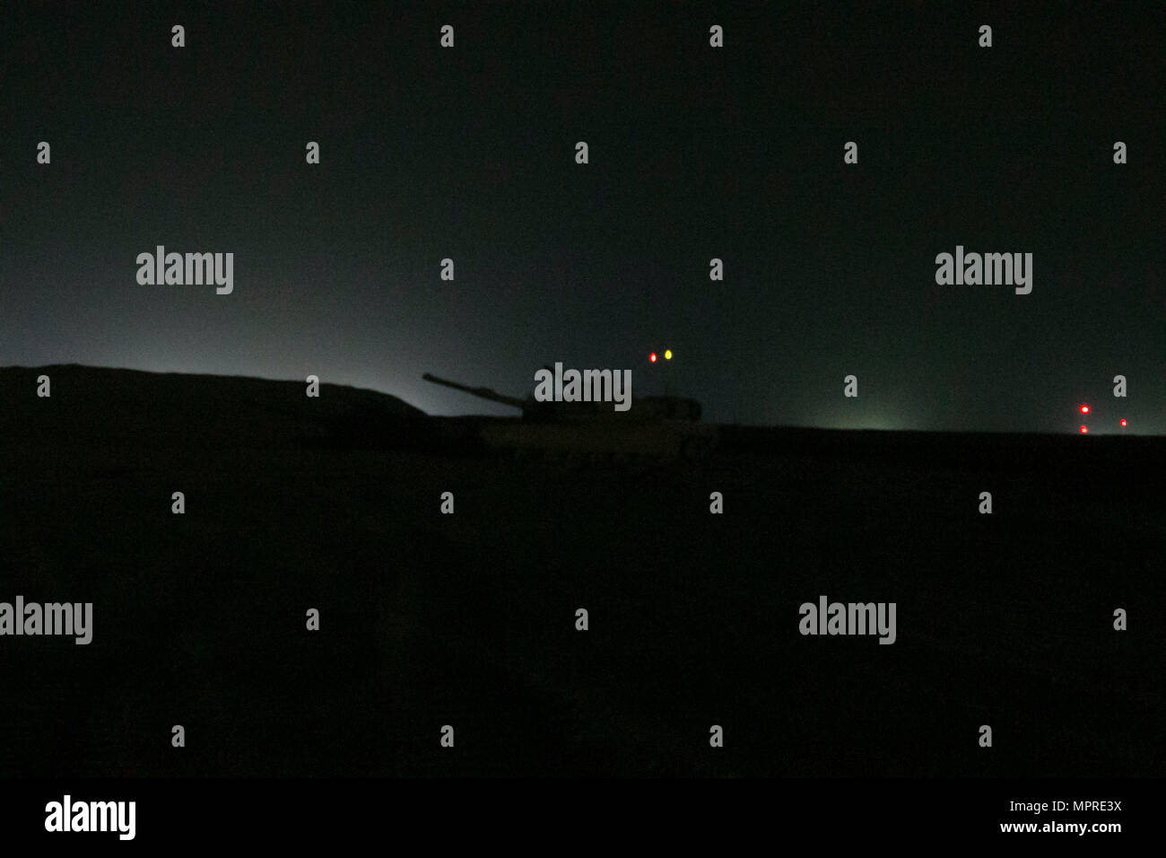 A 3rd Armored Brigade Combat Team, 1st Cavalry Division M1A2 Abrams Main Battle Tank crew waits its turn to occupy the battle position and engage targets during the night fire portion of the brigade's Table VI qualifications at the Udairi Range Complex March 29. The brigade tank and Bradley crews spent about two weeks in the field conducting sustainment gunnery to ensure all the crews qualified at day and night fire to maintain proficiency. (U.S. Army photo by Staff Sgt. Leah R. Kilpatrick, 3rd Armored Brigade Combat Team Public Affairs Office, 1st Cavalry Division (released) Stock Photo