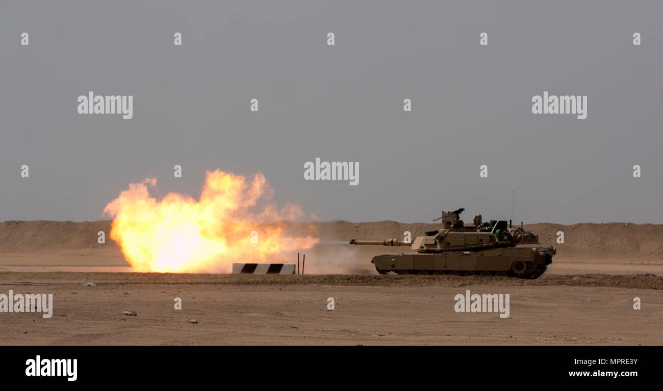 A 3rd Armored Brigade Combat Team, 1st Cavalry Division M1A2 Abrams Main Battle Tank engages targets during the brigade's Table VI qualifications at the Udairi Range Complex March 29. The brigade tank and Bradley crews spent about two weeks in the field conducting sustainment gunnery to ensure all the crews qualified at day and night fire to maintain proficiency. (U.S. Army photo by Staff Sgt. Leah R. Kilpatrick, 3rd Armored Brigade Combat Team Public Affairs Office, 1st Cavalry Division (released) Stock Photo