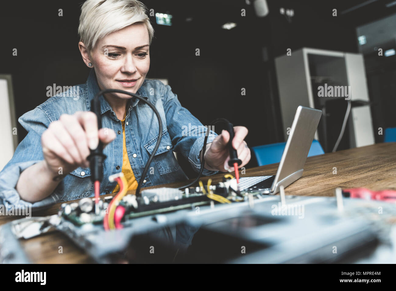 Woman working on computer equipment Stock Photo