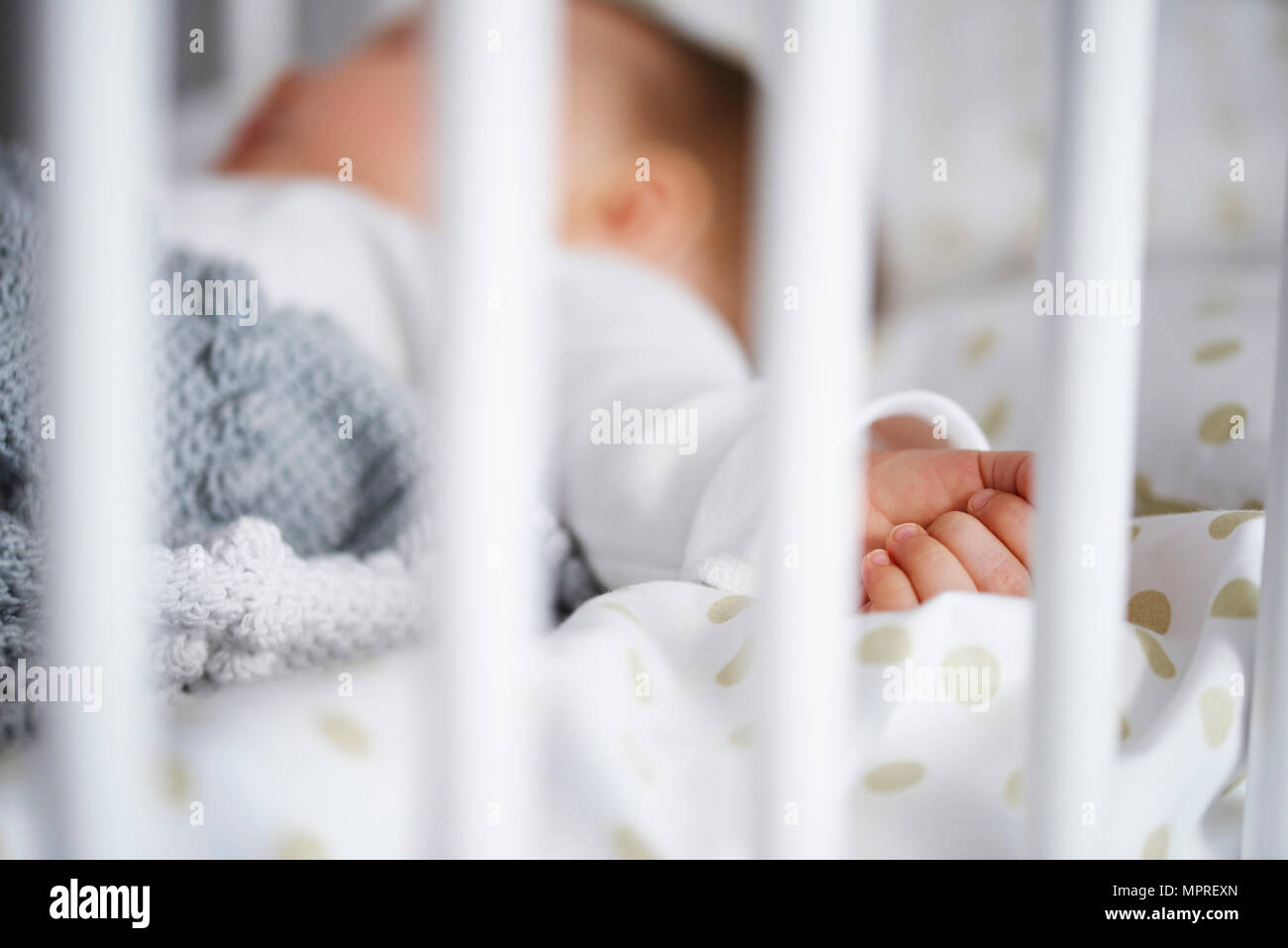 Defocused shot of baby lying in crib Stock Photo