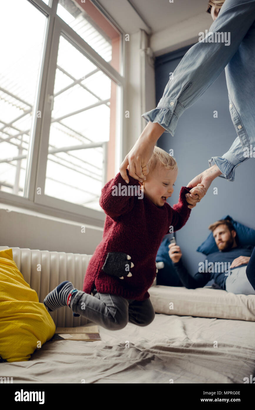 Happy family playing with their son at home Stock Photo
