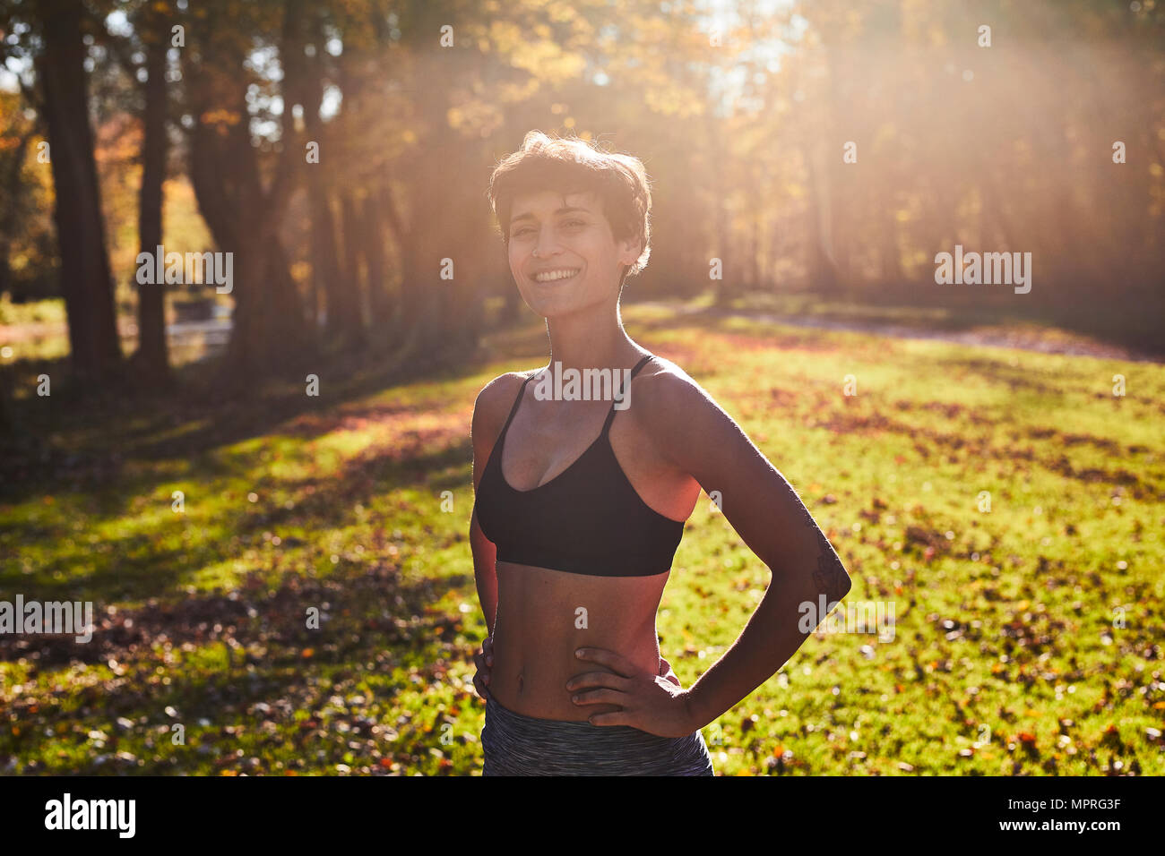 Mid adult woman at forest glade during training Stock Photo