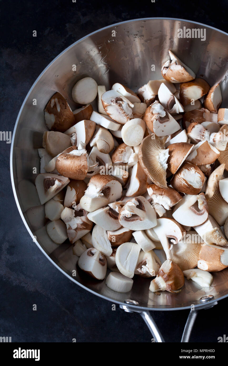 Raw champignons and king trumpet mushrooms in pan Stock Photo