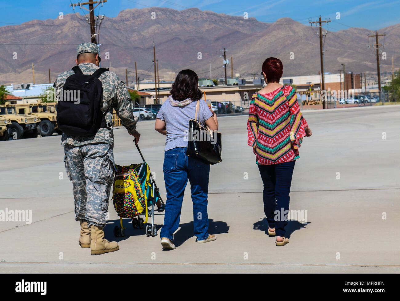 Rustie Milam, Sgt. William Thomas Warren Jr., Nancy Nicole Adame-Warren, and William Ezra Warren, walk back to the Headquarters and Headquarters Battery, 32nd Army Air and Missile Defense Command, Fort Bliss, Texas, April 6, 2017. The goal is to stay ready by assisting families inside and outside the unit’s element. (U.S. Army photo by Sgt. Aura E. Conejos, 32d AAMDC Public Affairs) Stock Photo
