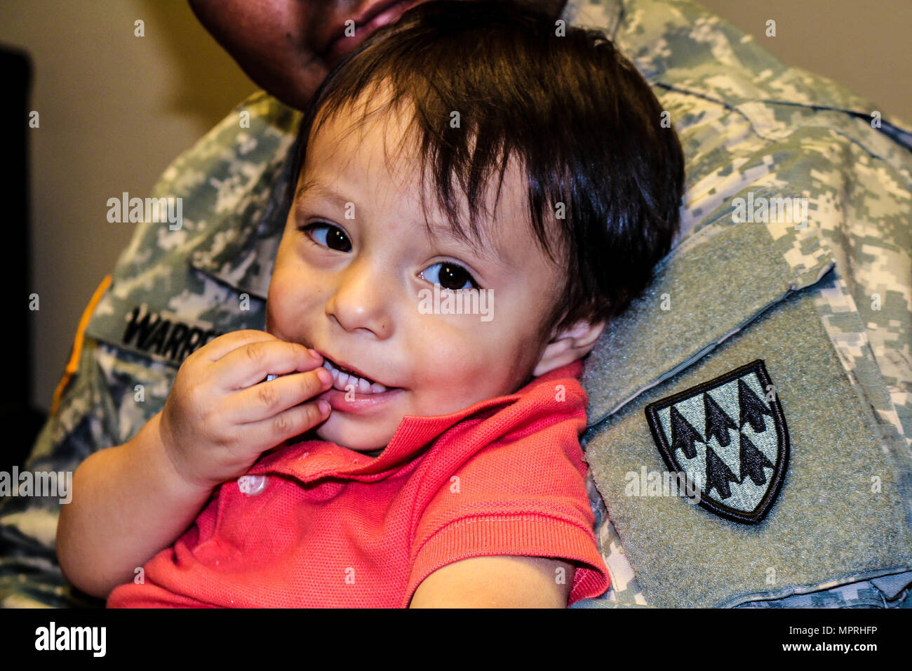 William Ezra Warren is held by his father, Sgt. William Thomas Warren Jr., United States Army Space and Missile Defense Command, at Headquarters and Headquarters Battery, 32nd Army Air and Missile Defense Command, Fort Bliss, Texas, April 6, 2017. During his emergency leave, the unit took charge of transferring him to 32nd AAMDC in order to stay with his family through the recovery process. (U.S. Army photo by Sgt. Aura E. Conejos, 32d AAMDC Public Affairs) Stock Photo