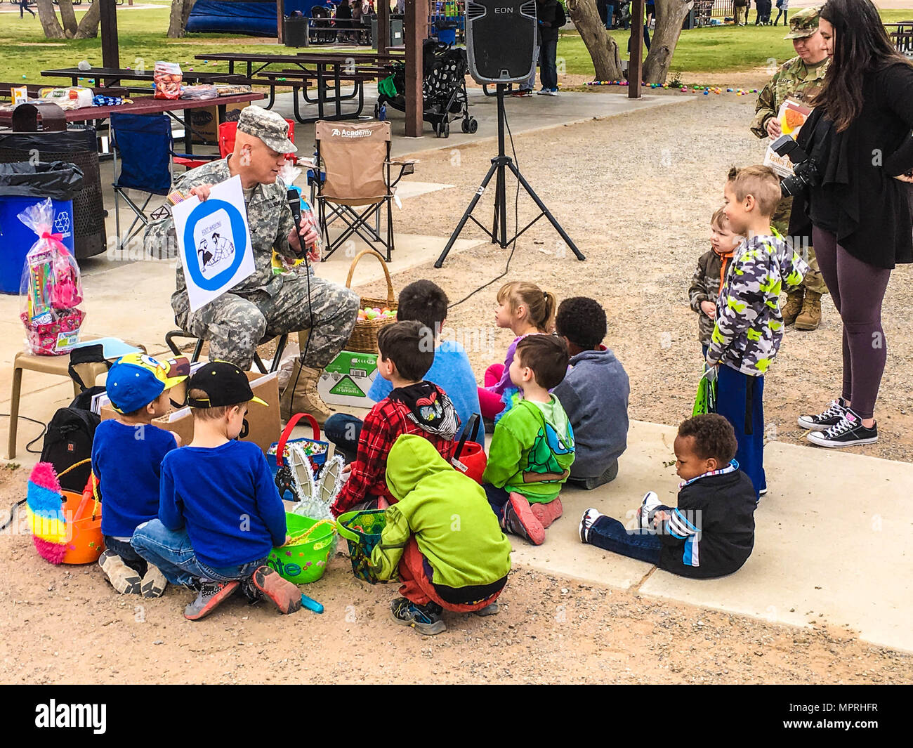 Col. Scott Sherretz, chaplain, 32nd Army Air and Missile Defense Command, reads the Easter story to a group of Soldiers’ children at Biggs Park, Fort Bliss, Texas, April 1, 2017. The goal is to stay ready by assisting families inside and outside the unit’s element. (U.S. Army photo by Sgt. 1st Class Brian G. Rhodes, 32d AAMDC Public Affairs) Stock Photo