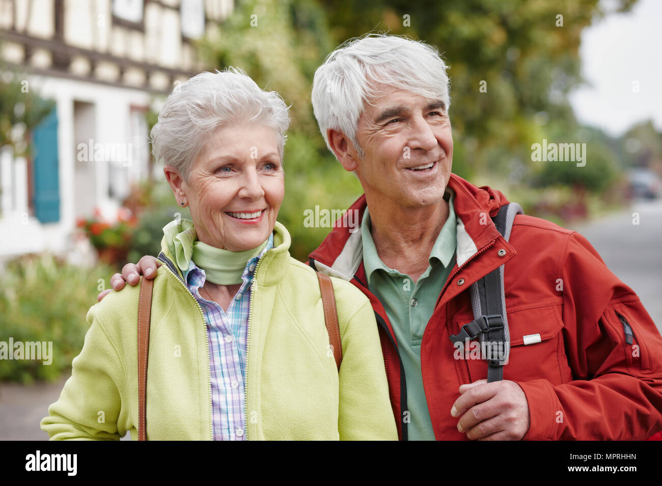 Germany, Ruedesheim, portrait of smiling senior couple watching something Stock Photo