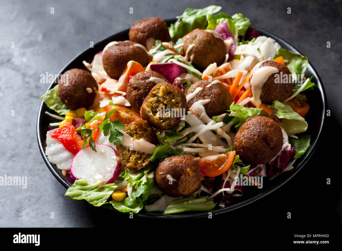 Bowl of mixed salad with vegetable balls Stock Photo