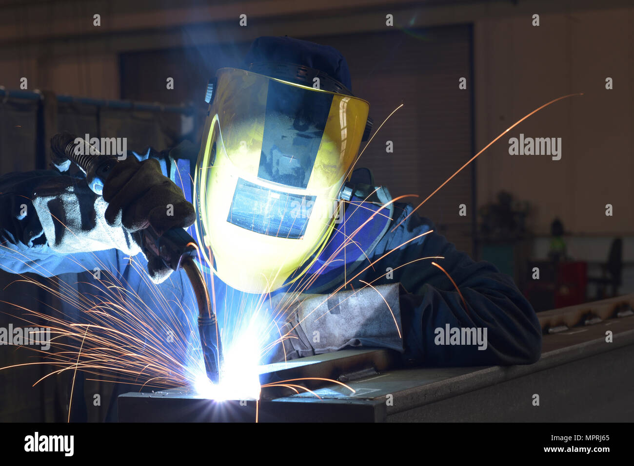 Welder at work in factory Stock Photo