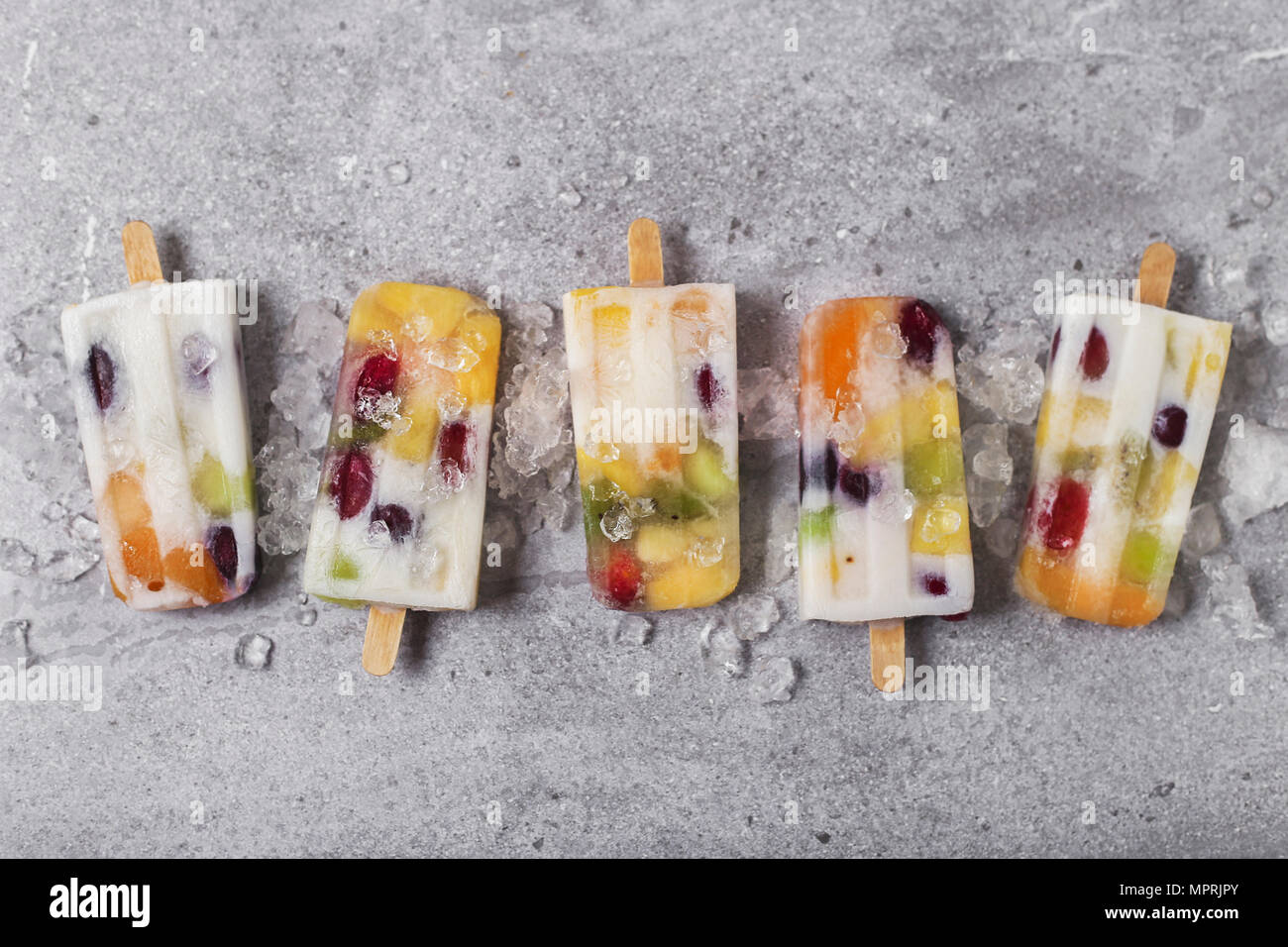 Homemade fruits and yogurt ice lollies on marble Stock Photo Alamy