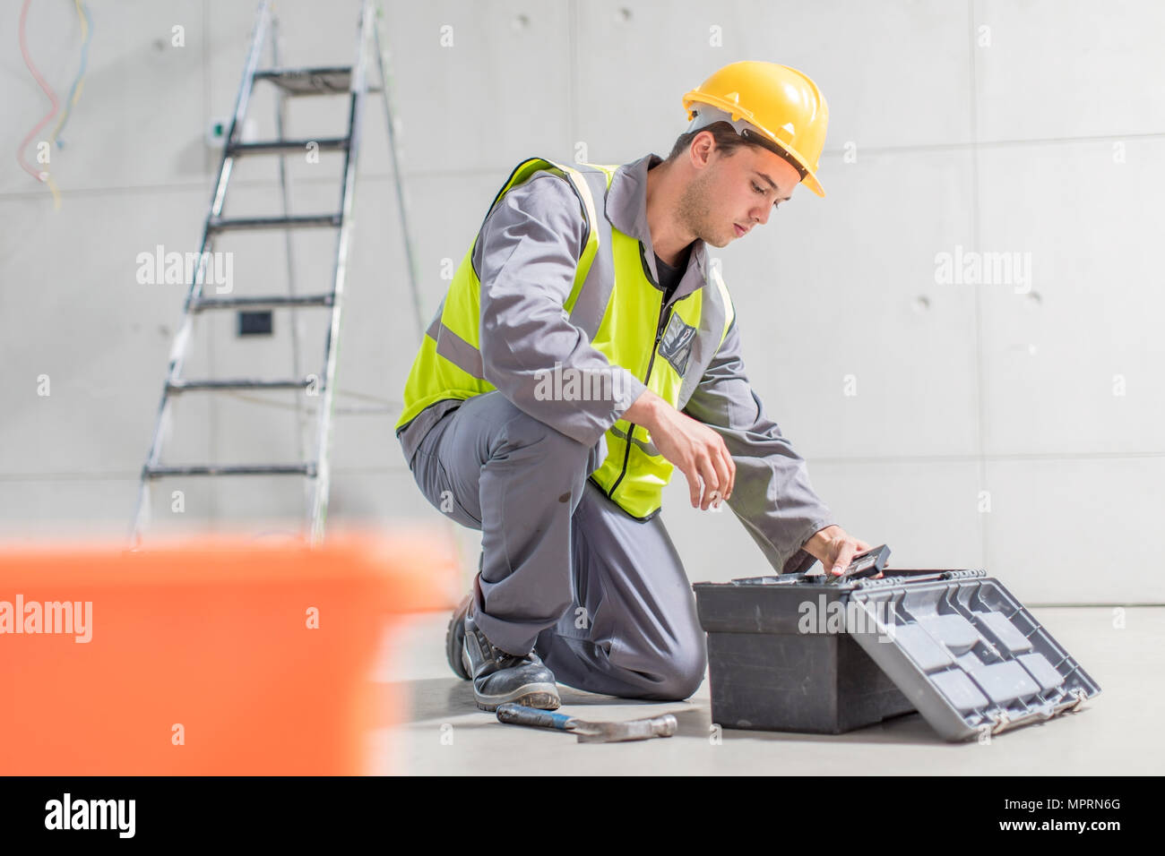 Construction Worker With Tool Box On Construction Site Stock Photo Alamy