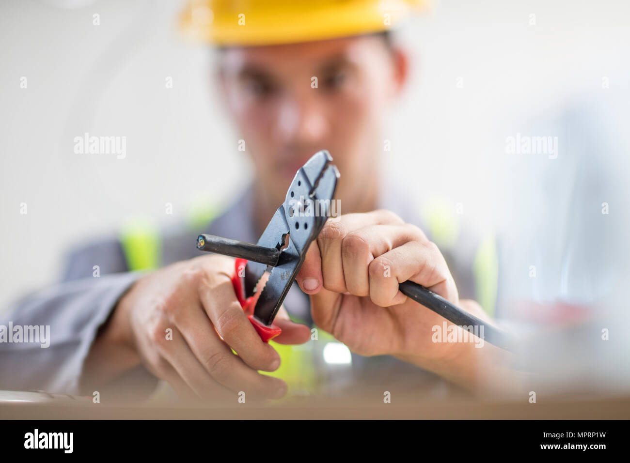 Close-up of electrician cutting wire Stock Photo