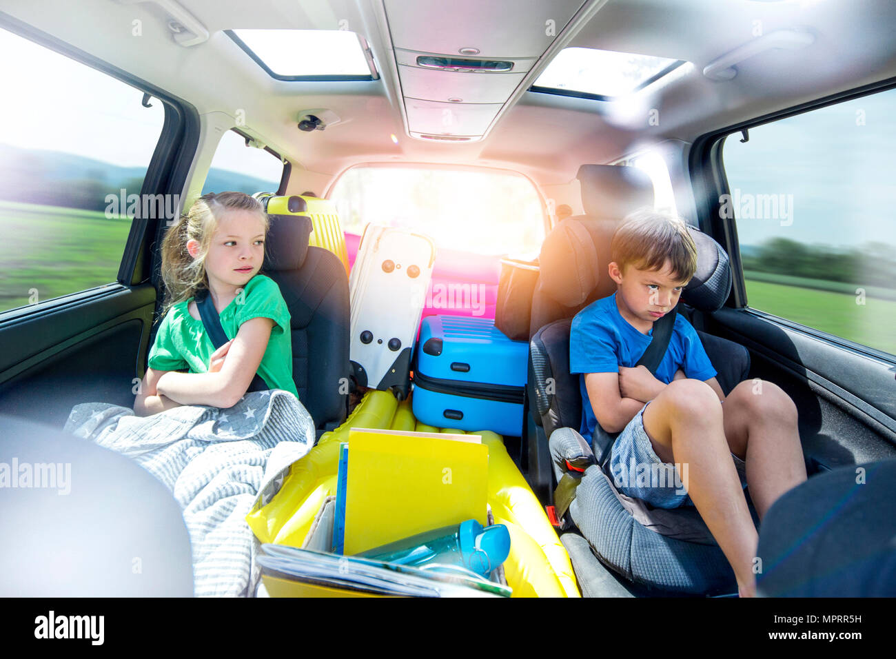 Have a long car journey. Shutterstock exhausted child sitting in the car on a long Journey. Siblings Holiday. Longing my car.