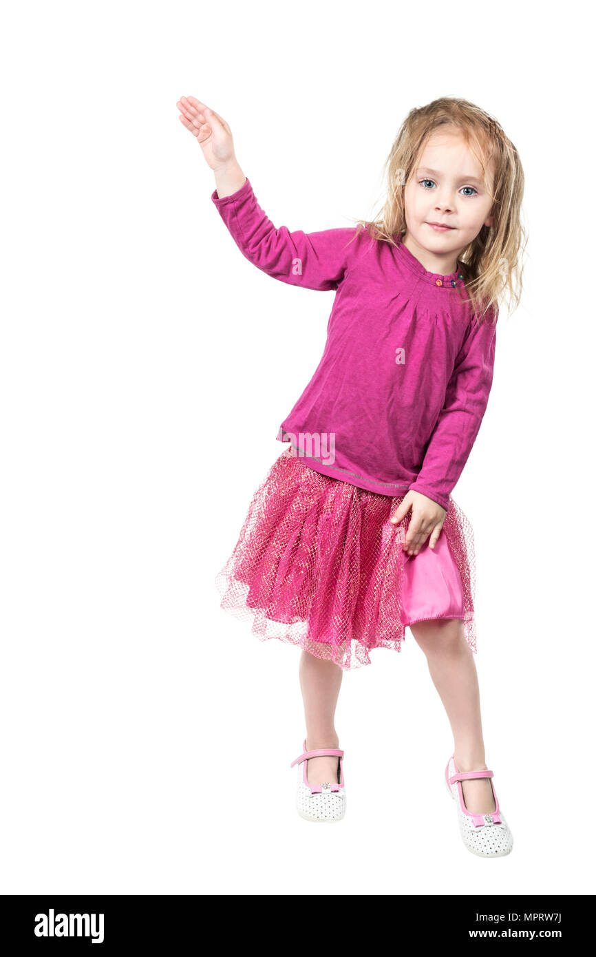 Little beautiful girl rested on one leg and points with her hand ...