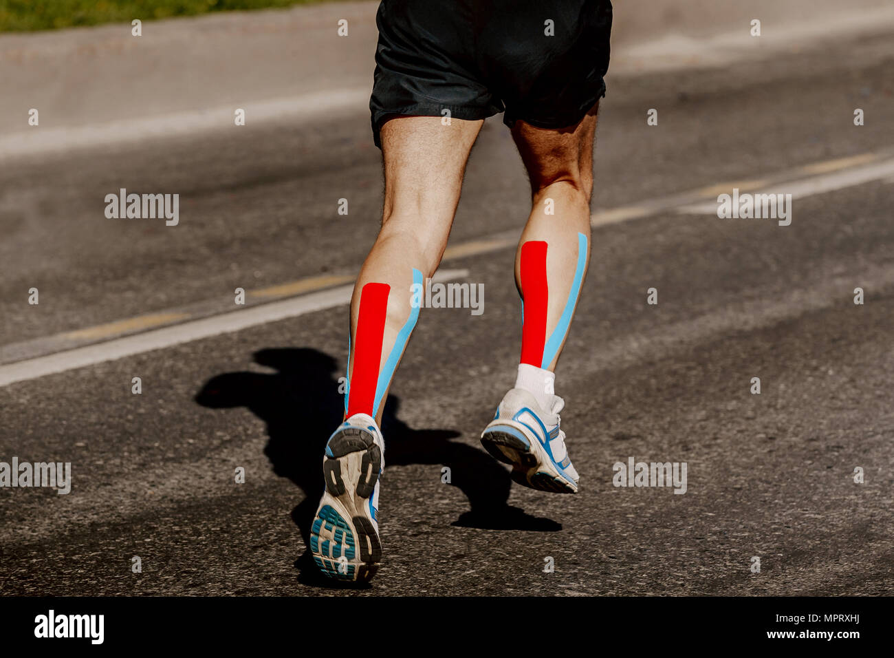 legs runner with kinesio tape on calf muscle running street Stock Photo Alamy