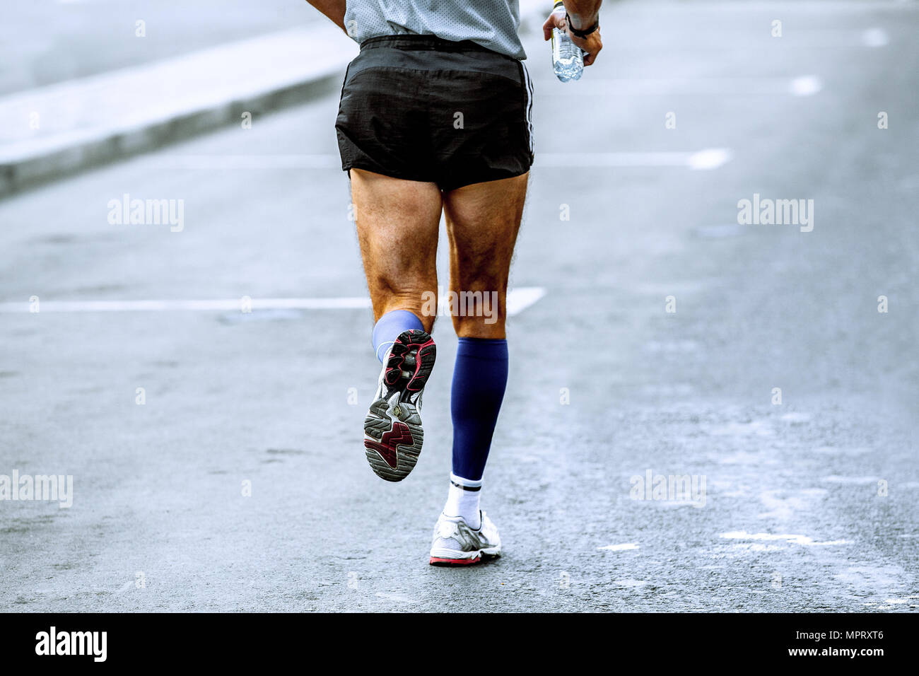 back athlete runner in hand water bottle run in street Stock Photo Alamy