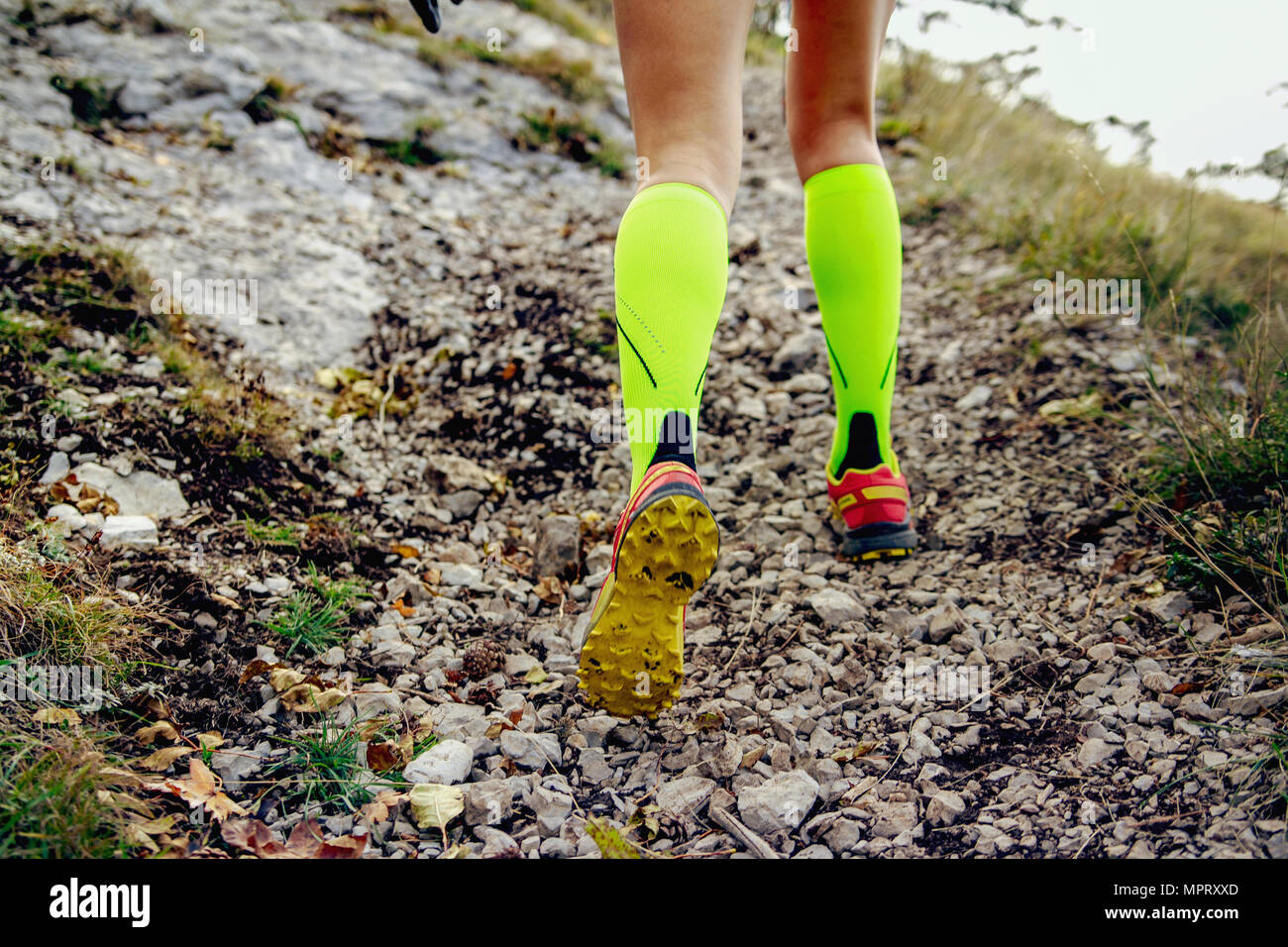 legs female runner in yellow compression socks running mountain trail Stock  Photo - Alamy