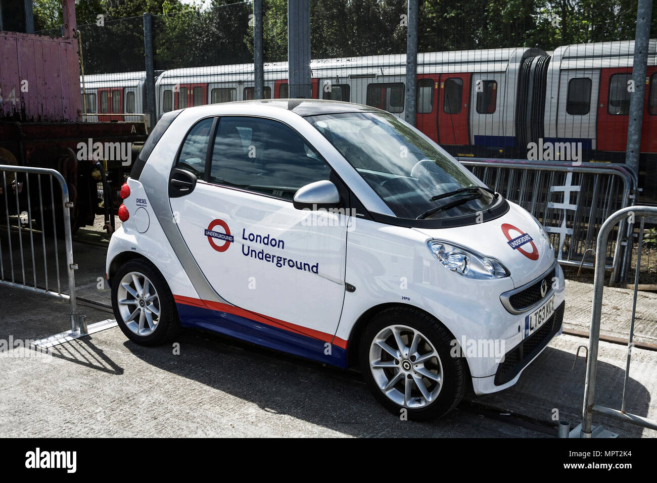 London Underground: London Tube and small city car. Stock Photo