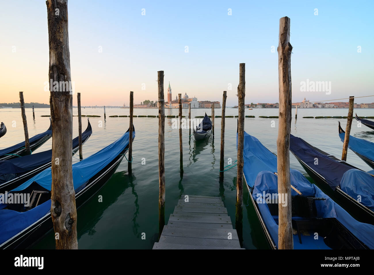 Condolas and wooden pier in Venice, Italy Stock Photo - Alamy