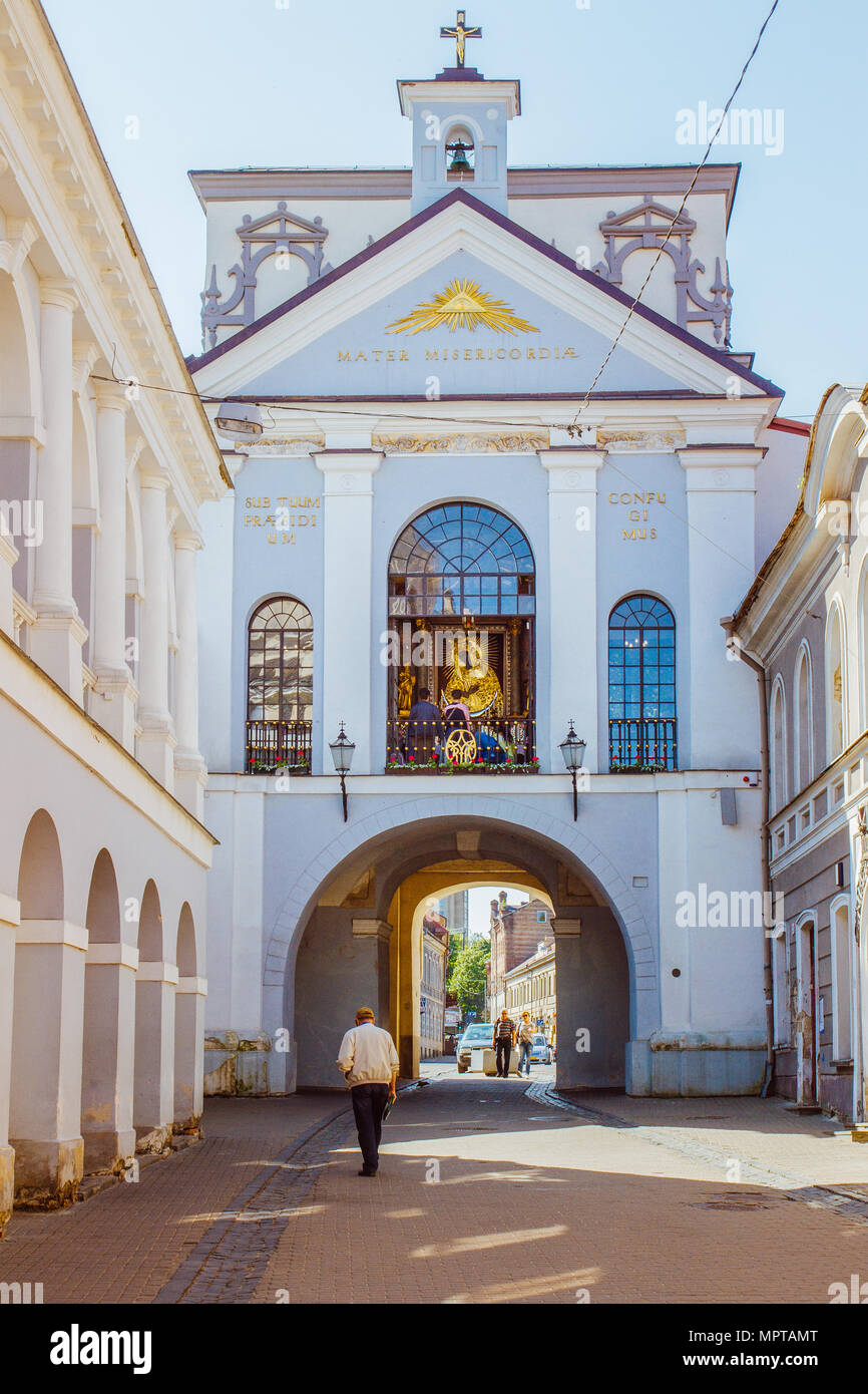 People are walking towards the Gate of Dawn in Vilnius, Lithuania Stock Photo