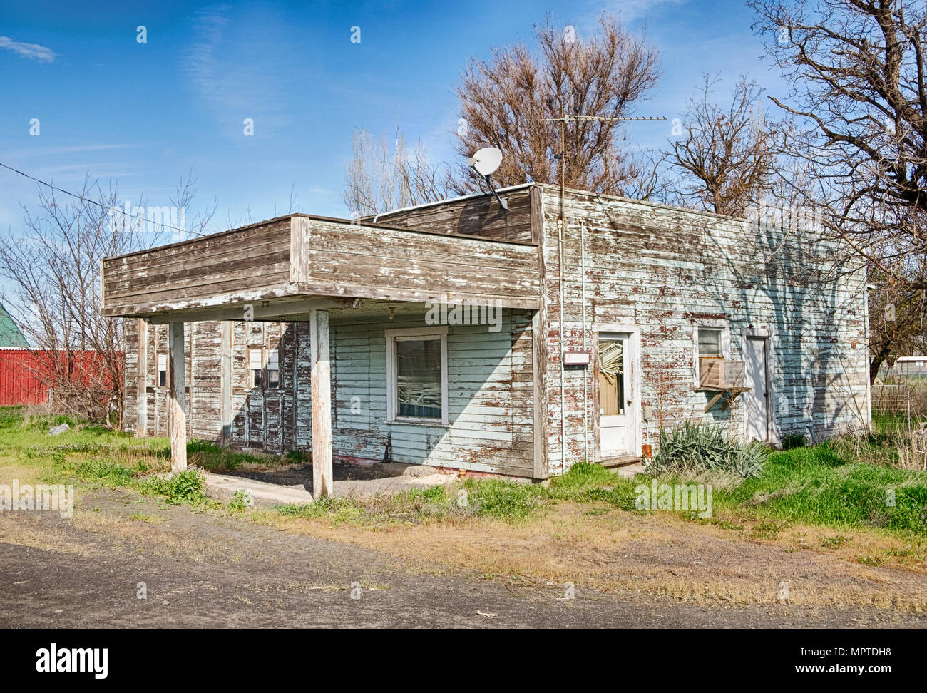 An old service station by the side of the highway in Lowden, Washington with a covered service area is gradually falling apart. Stock Photo