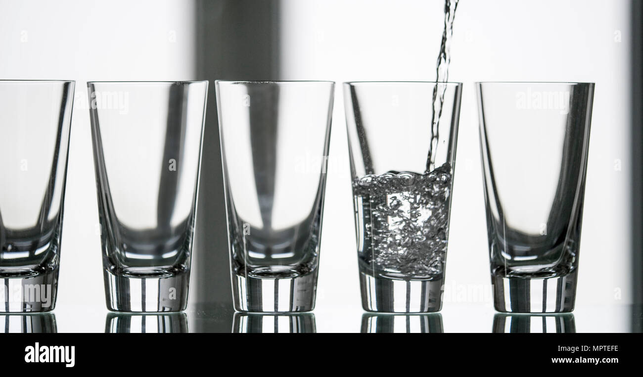 pure, natural freshwater being poured into a classical cristal glass ...