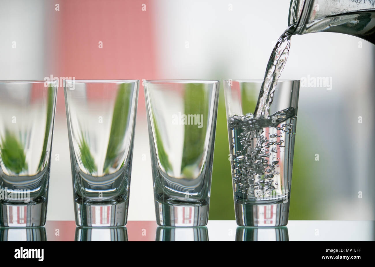 pure, natural freshwater being poured into a classical cristal glass ...