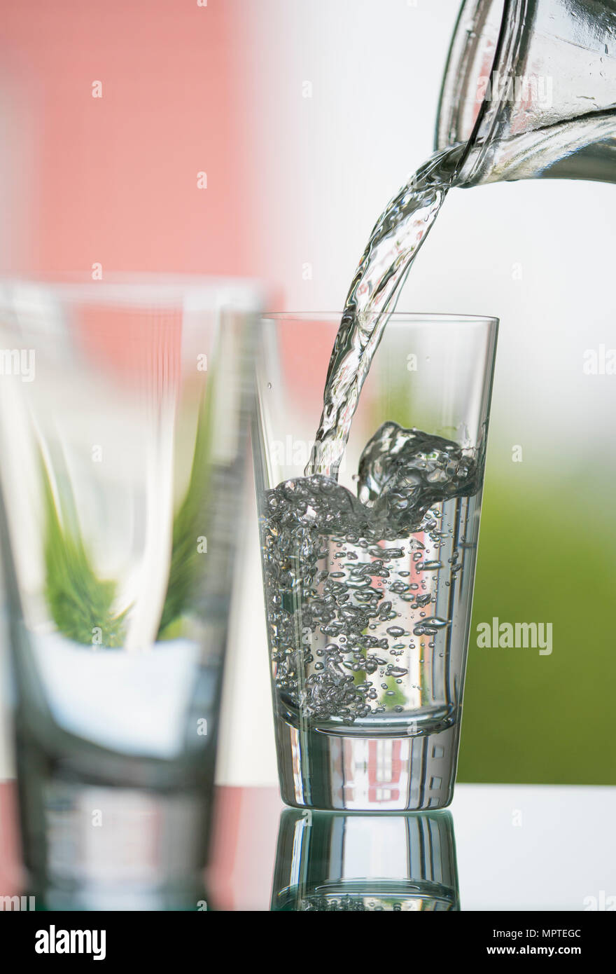 pure, natural freshwater being poured into a classical cristal glass ...