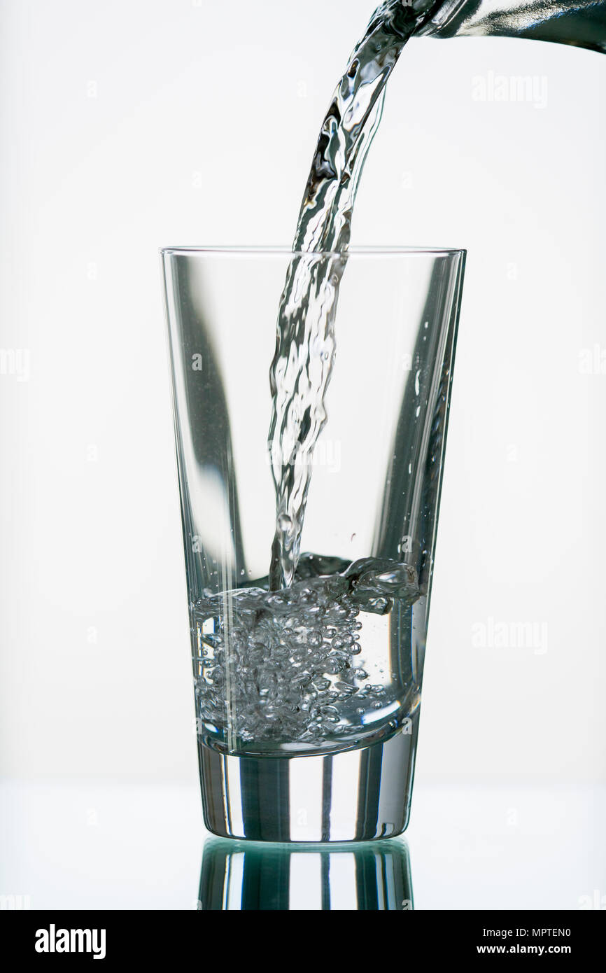 pure, natural freshwater being poured into a classical cristal glass ...