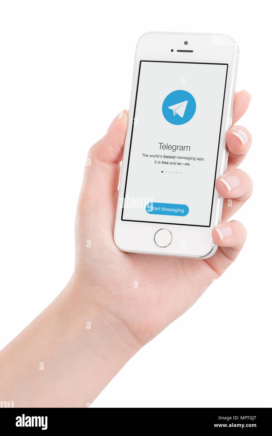 Telegram messenger on iPhone screen in woman hand. Stock Photo