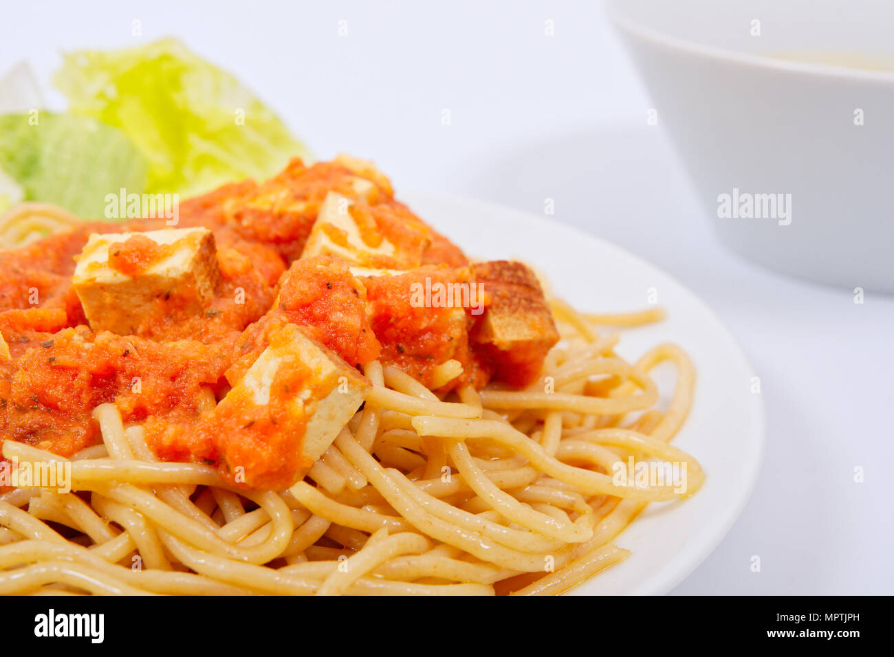 Bolognese spaghetti with tofu on a white background Stock Photo Alamy