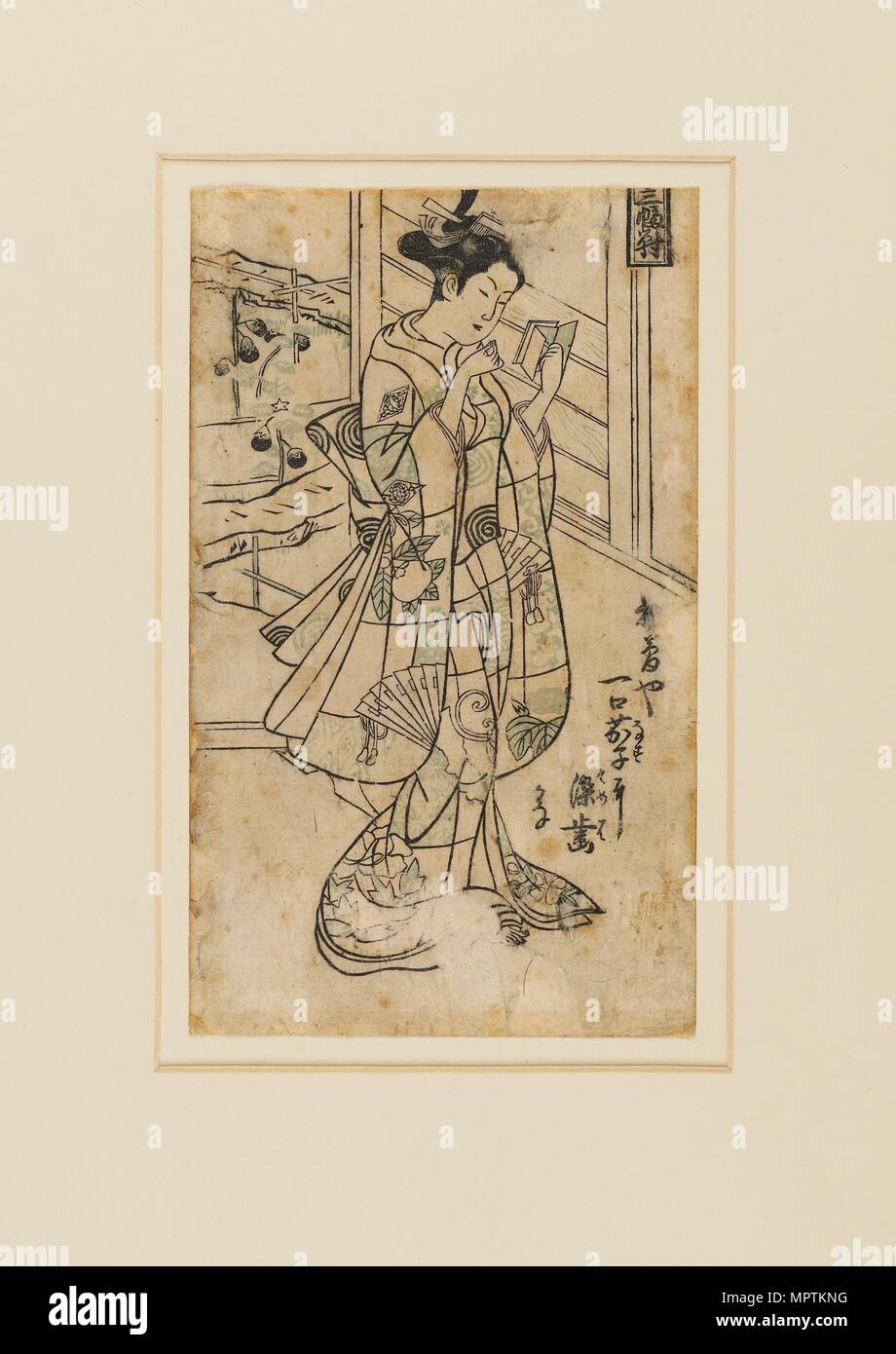 Woodblock print - Onoe Kikingoro I as a woman reading a book, 18th century Artist: Okumura Masanobu. Stock Photo