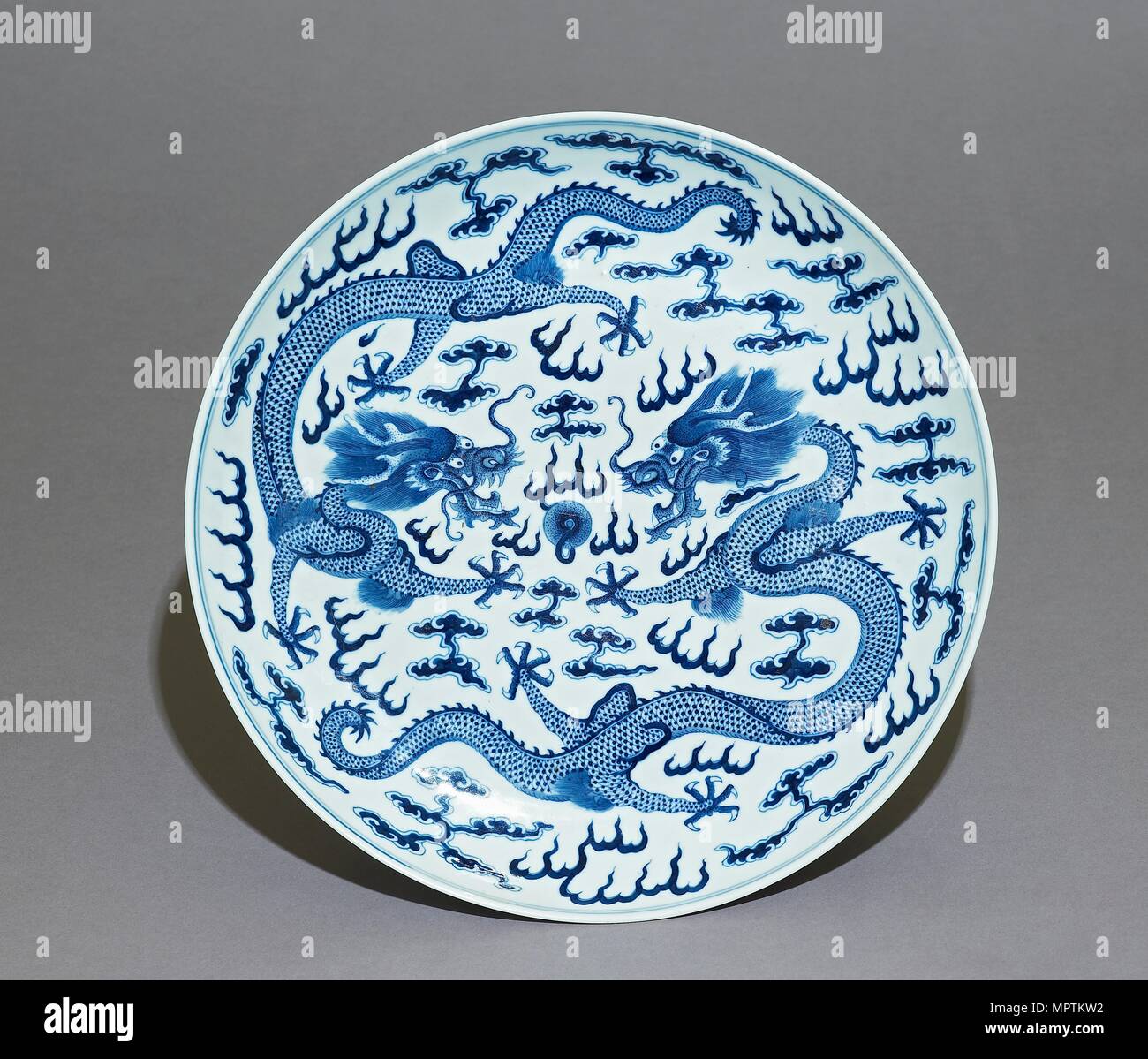 Blue-and-white dish, dragons chasing a flaming pearl, Qing Dynasty, Guangxu Period (1875 - 1908)) Artist: Unknown. Stock Photo