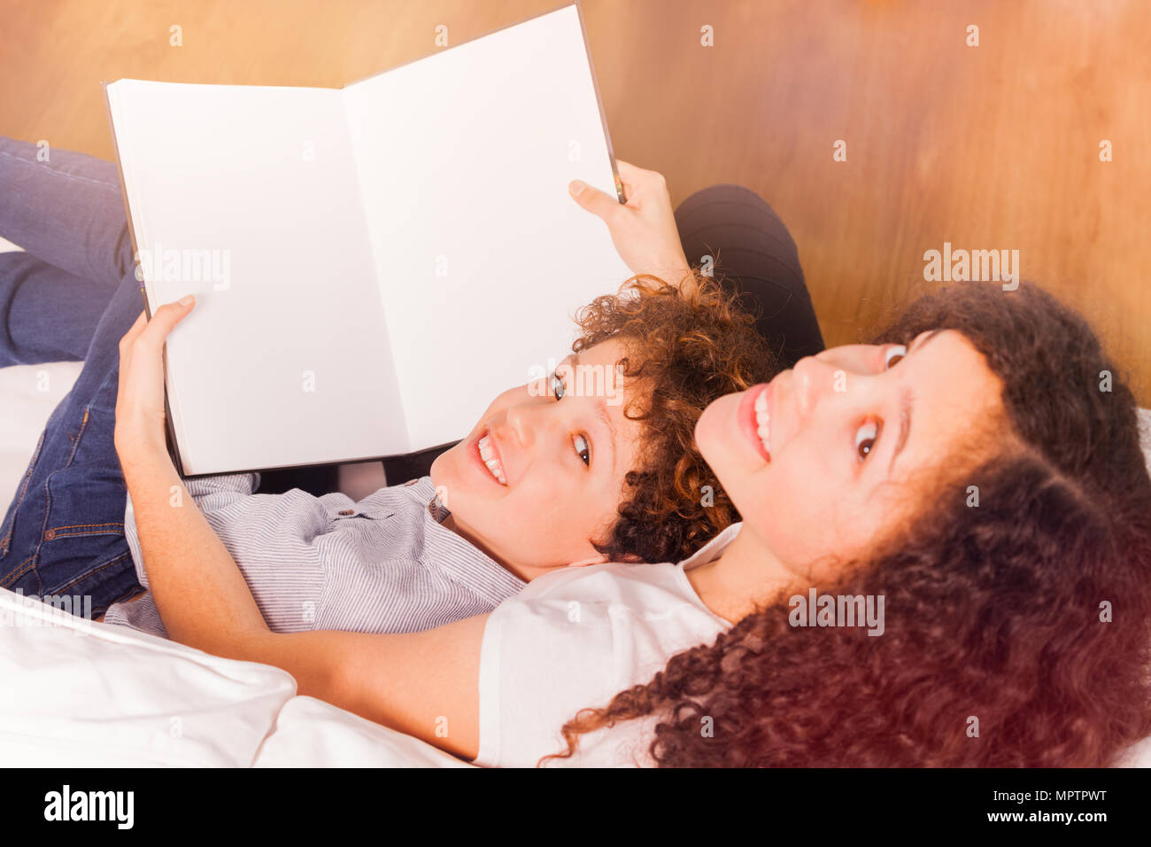 Top view portrait of happy teenage boy and girl reading book together ...