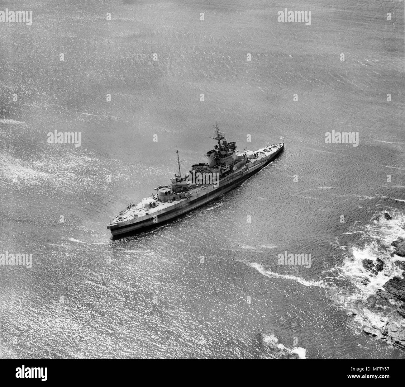 HMS 'Warspite' aground in Prussia Cove, Cornwall, 1947. Artist: Aerofilms. Stock Photo