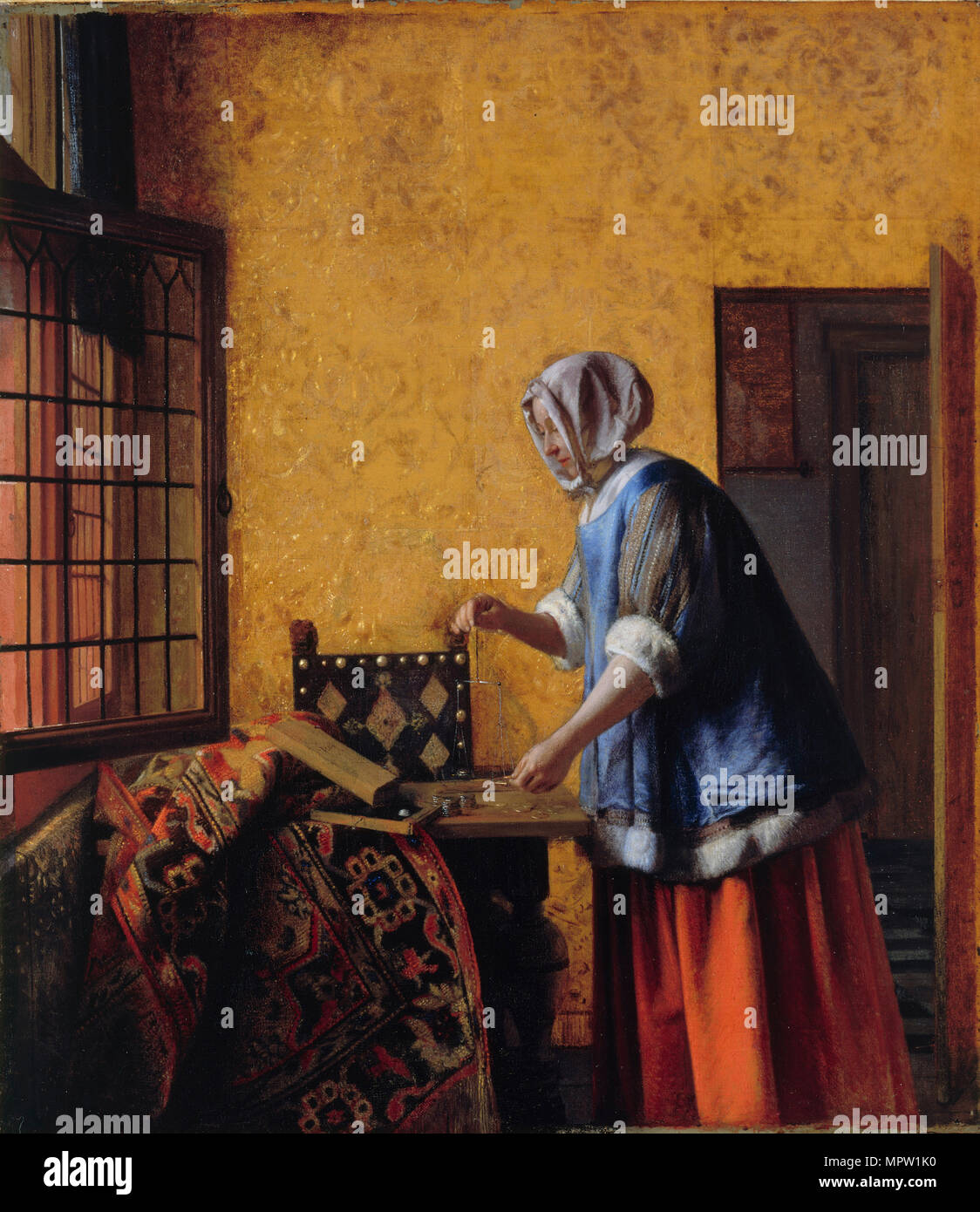 Woman Weighing Gold, ca 1662. Stock Photo