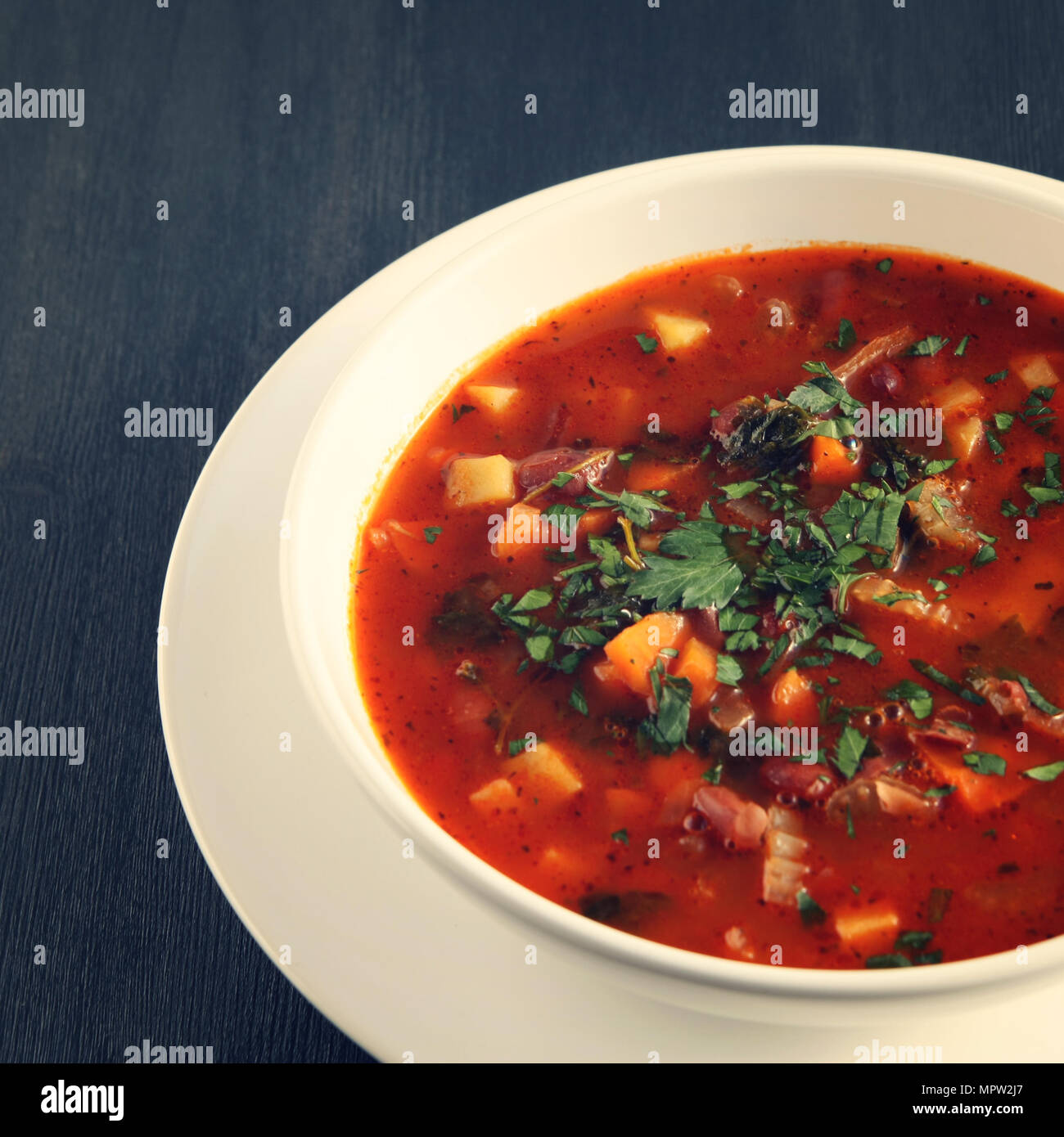 Tomato soup with red beans, potato and carrot. Vegan diet. European cuisine. Vegetarian dish. Main course. Organic meal. Toned photo. Stock Photo