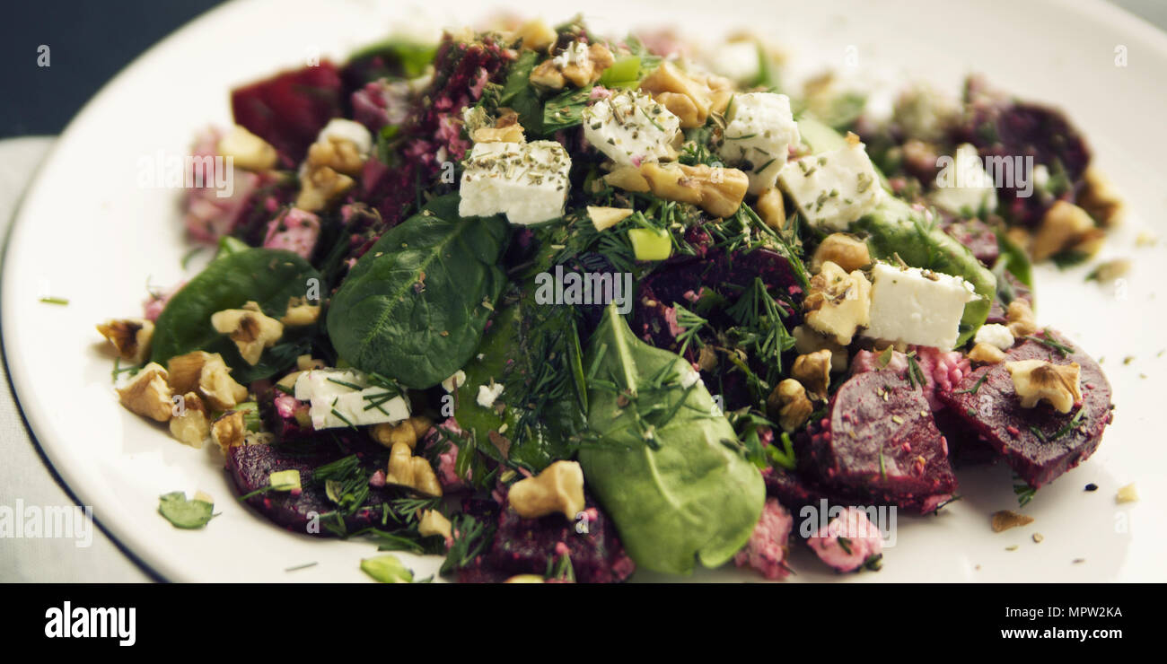 Beetroot salad with cottage cheese, baby spinach and walnuts. European cuisine. Organic food. Vegetarian appetizer. Healthy lifestyle. Simple side dis Stock Photo