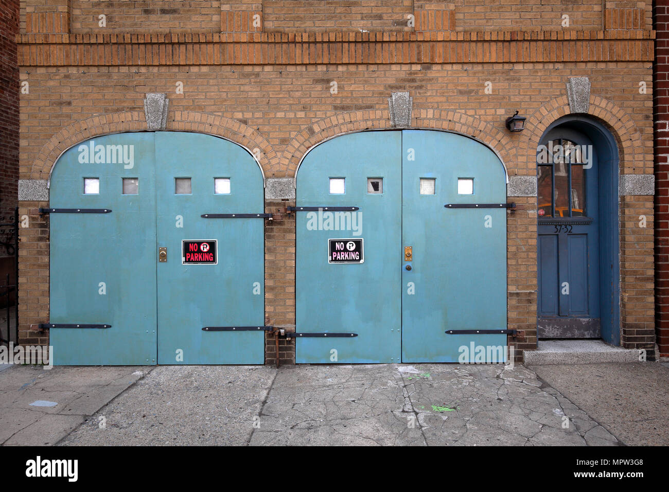 Building With Arched Garage Doors In Astoria New York City Stock