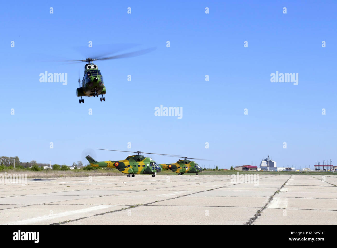 SUPPORT FACILITY DEVESELU, Romania (April 11, 2017) Three IAR-330 Puma medium transport helipcopters take off from Naval Support Facility Deveselu carrying Commander, U.S. Air Forces in Europe and U.S. Air Forces in Africa, Commander, Allied Air Command, and Director, Joint Air Power Competency Centre, Kalkar, Germany Gen. Tod D. Wolters, Lt. Gen. Laurian Anastasof, Chief of Romanian Air Force, Brig. Gen. Dieter E. Bareihs, U.S. Air Force Director of Plans, and staff. NSF Deveselu plays a key role in ballistic missile defense in Eastern Europe. The installation's operations enable the responsi Stock Photo