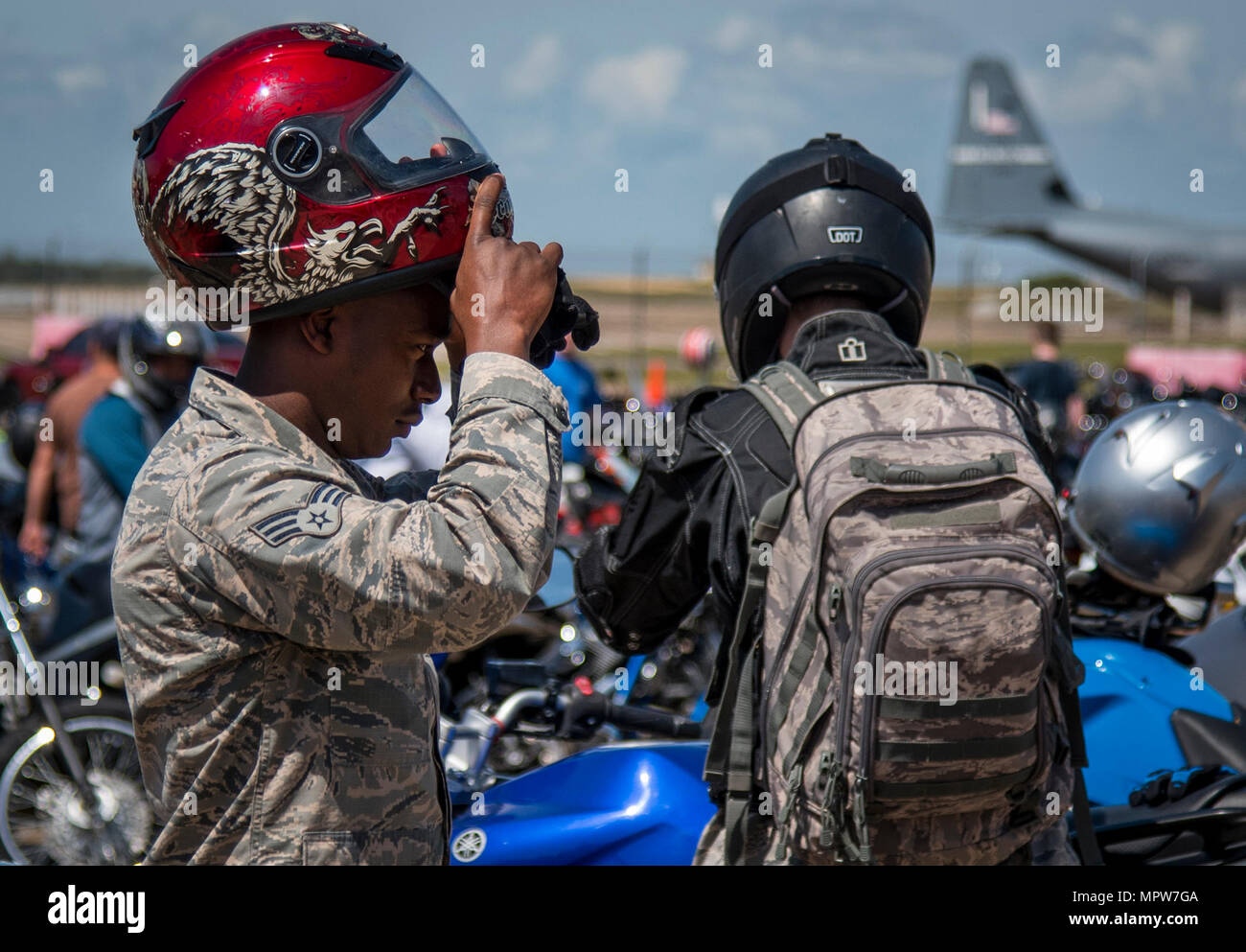 A senior airman puts on his helmet after the annual motorcycle safety rally at Eglin Air Force Base, Fla., April 14.  More than 500 motorcyclists came out for the event that meets the annual safety briefing requirement for base riders.  (U.S. Air Force photo/Samuel King Jr.) Stock Photo
