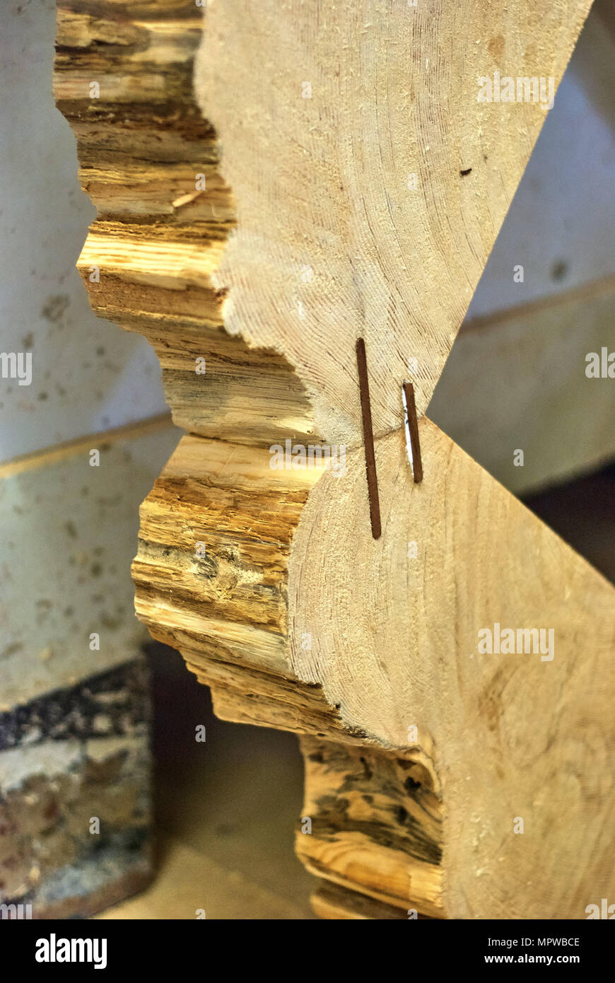 Dowel joinery. Gluing and inserting dowels into a wooden frame. Close-up Stock Photo