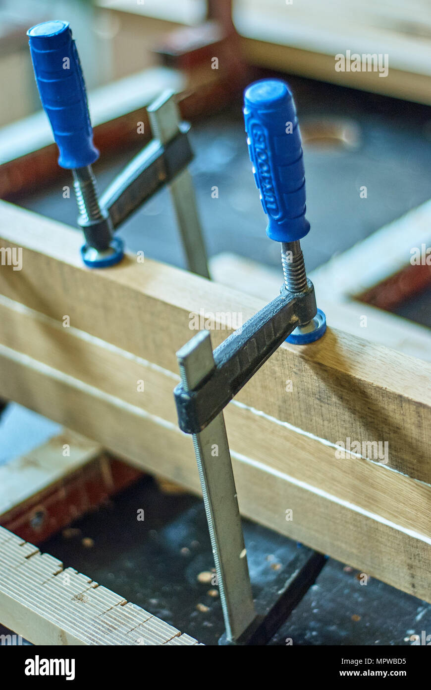 Joinery. Gluing and clamping wooden planks. Wooden edgeglued panels