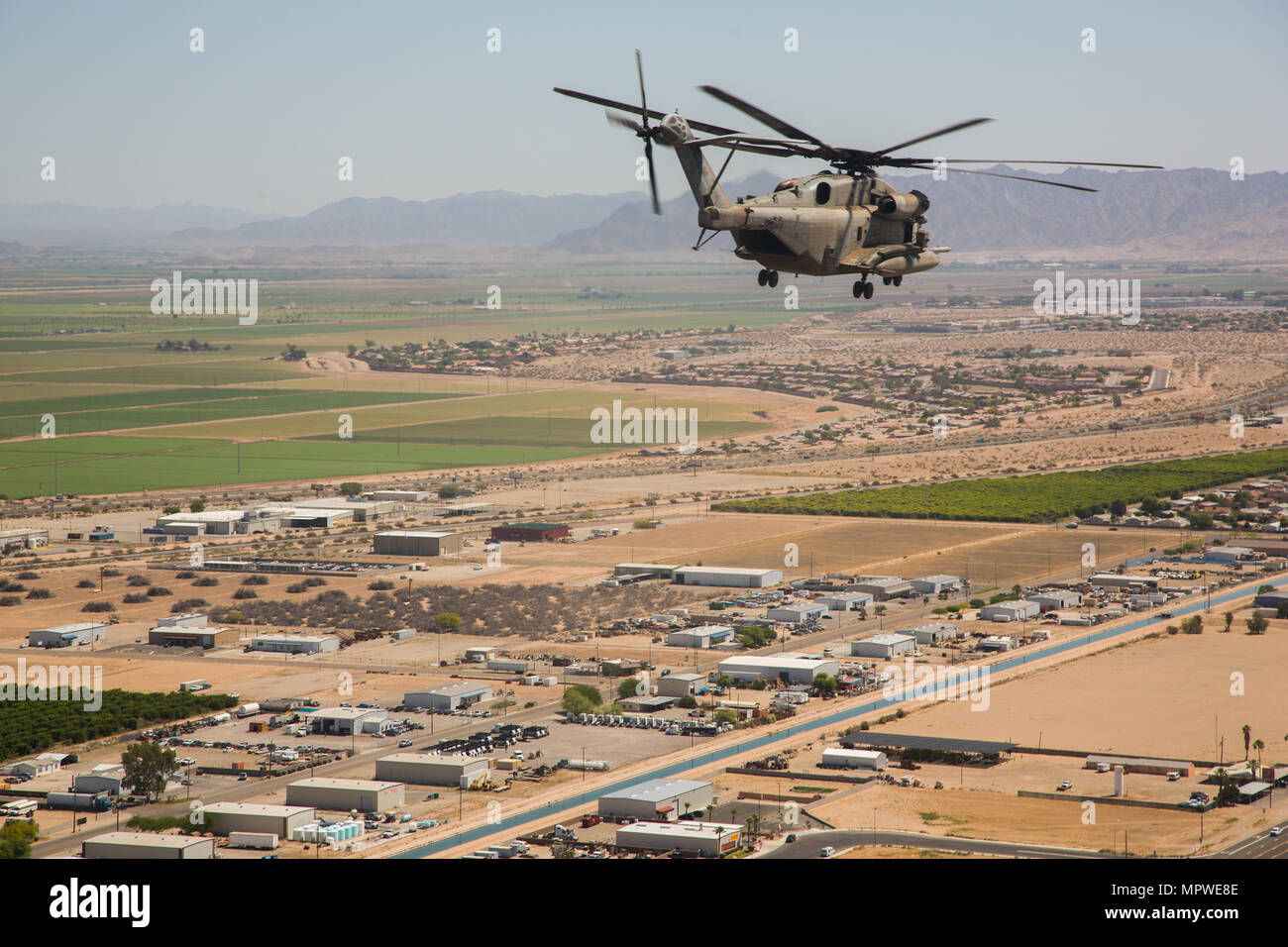 A CH-53E Super Stallion assigned to Marine Heavy Helicopter Squadron (HMH) 466 flies over Yuma, Ariz. in formation while transporting Marines during an exercise in part of Weapons and Tactics Instructors course (WTI) 2-17 near Yuma, Ariz., April 20, 2017. WTI is held biannually at Marine Corps Air Station (MCAS) Yuma, Ariz., to provide students with detailed training on the various ranges in Arizona and California. (U.S. Marine Corps photo by Cpl. Trever A. Statz/Released) Stock Photo