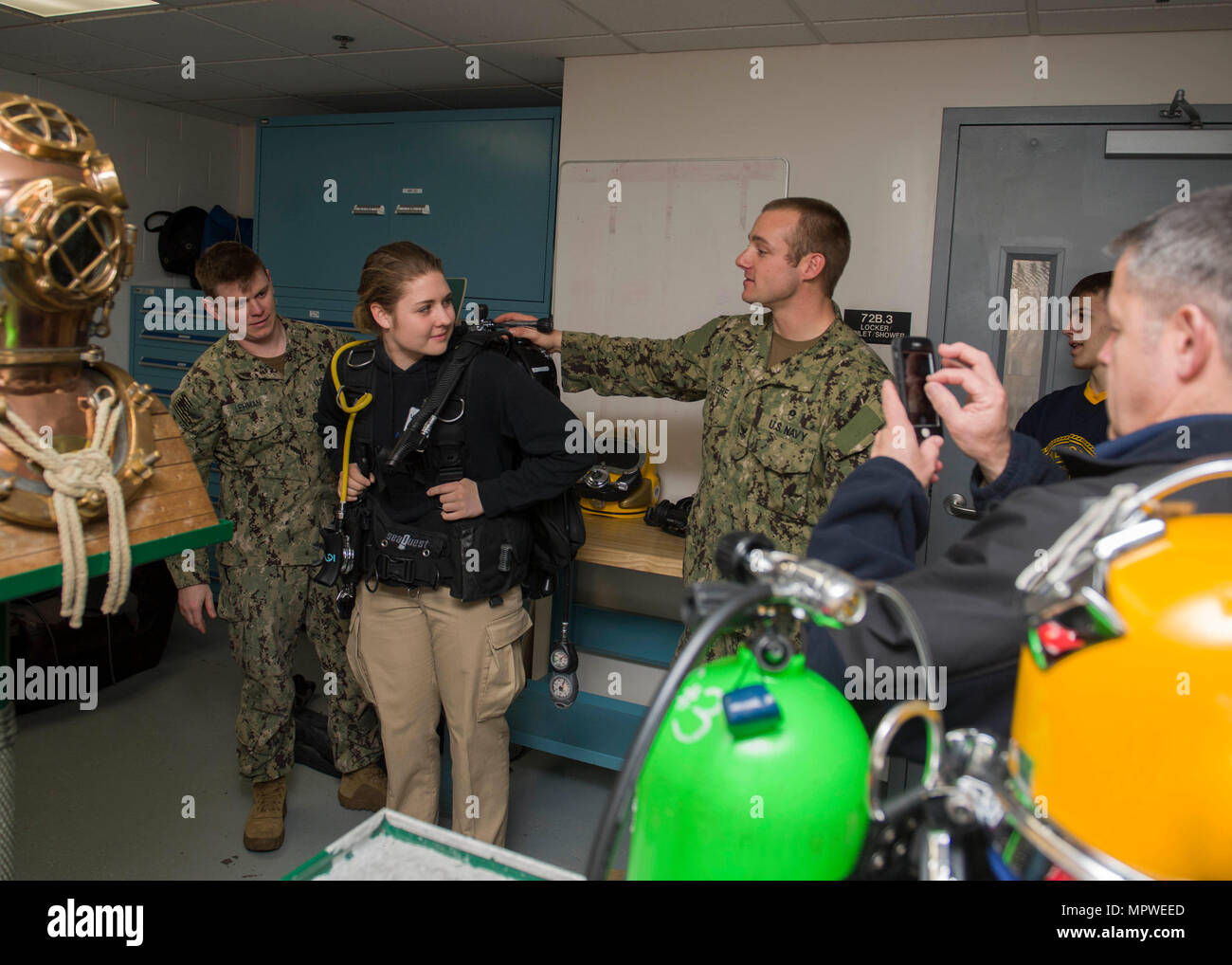 140420-N-LQ926-092 EVERETT, Wash. (April 20, 2017) Navy Diver 2nd Class Eric J. Lehman (Left) and Navy Diver 2nd Class Justin R. Rivere, assigned to the Puget Sound Navy Shipyard and Intermediate Maintenance Facility dive locker, demonstrate the weight of a self contained underwater breathing apparatus (SCUBA) during a Burlington-Edison High School Navy Junior Recruit Officer Training Command (JROTC) visit to the Navy dive locker at Naval Station Everett (NSE). While aboard NSE the Burlington-Edison High School JROTC toured the Navy dive locker, received a briefing on the use of a hyperbaric c Stock Photo
