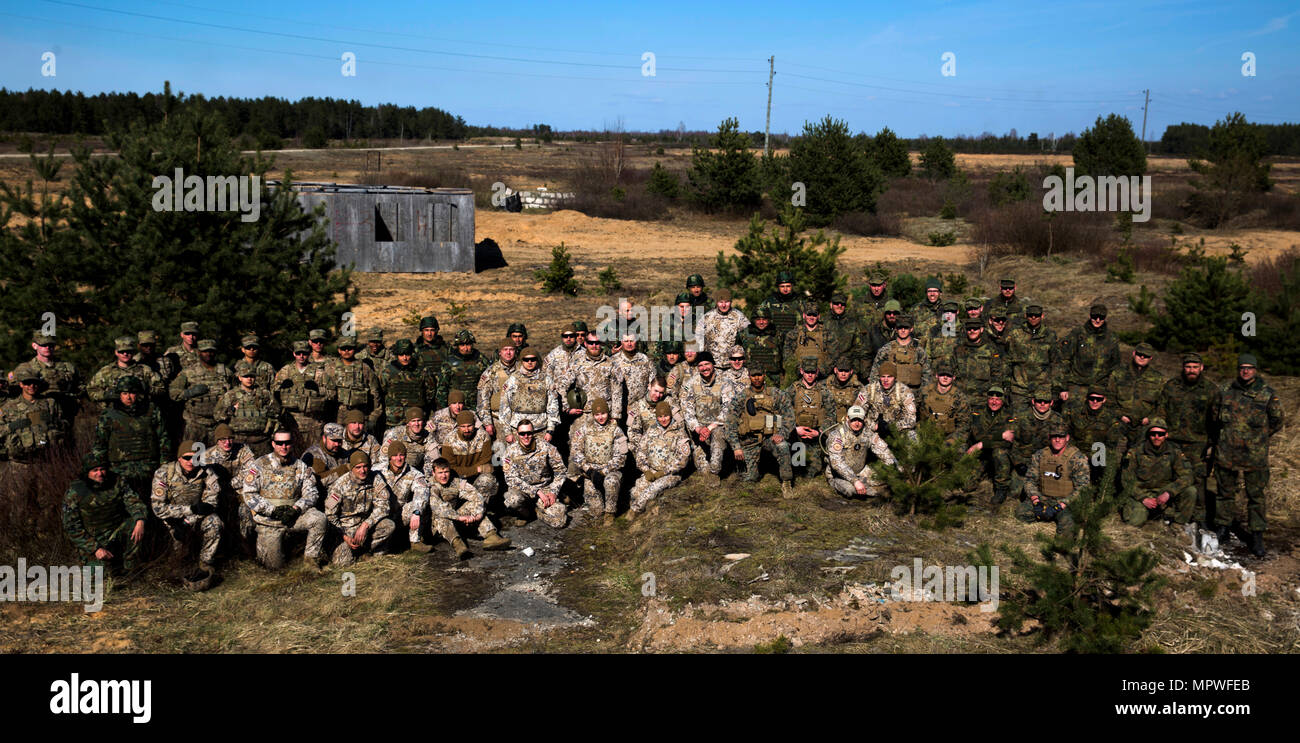 U.S. Marines with Black Sea Rotational Force 17.1 and NATO Allies pose for a photo during breach training during Exercise Summer Shield aboard Adazi Military Base, Latvia, April 20, 2017. Exercise Summer Shield is a multinational NATO exercise. (U.S. Marine Corps photo by Sgt. Patricia A. Morris) Stock Photo
