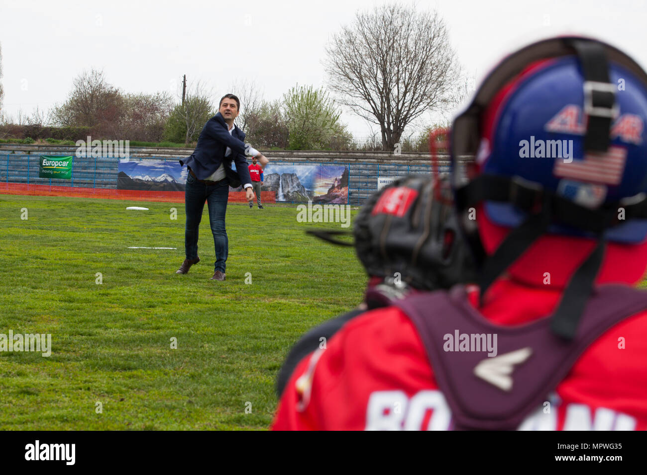 The mayor of Constanta, Decebal Fagadau, throws the first pitch of the Jackie Robinson Day baseball game between U.S. Marines with the Black Sea Rotational Force 17.1 and a Romanian team in Constanta, Romania, April 15, 2017. The Marines and the Romanian players all wore the number 42 jersey in honor of the 70th anniversary of Robinson becoming the first African American player in the Major League Baseball history. (U.S. Marine Corps photo by Cpl. Emily Dorumsgaard) Stock Photo