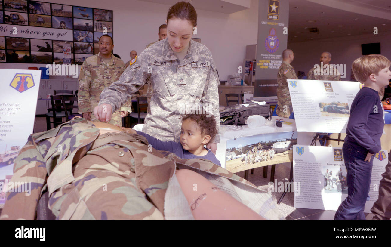 KAISERSLAUTERN, Germany — Sgt. Pattisue Graham, a member of the Medical  Support Unit - Europe, explains a CPR mannequin to a child Friday, April 21  at the Kaiserslautern Military Community Center on