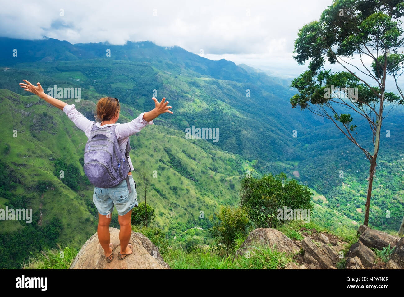 Caucasian woman standing and looking on mountain and valley. Stock Photo